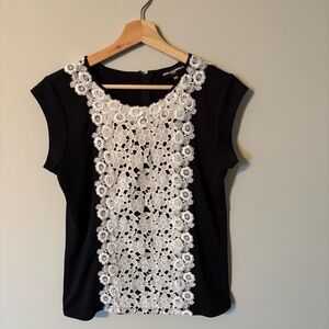 Karl Lagerfeld black top with a prominent white lace floral panel.
